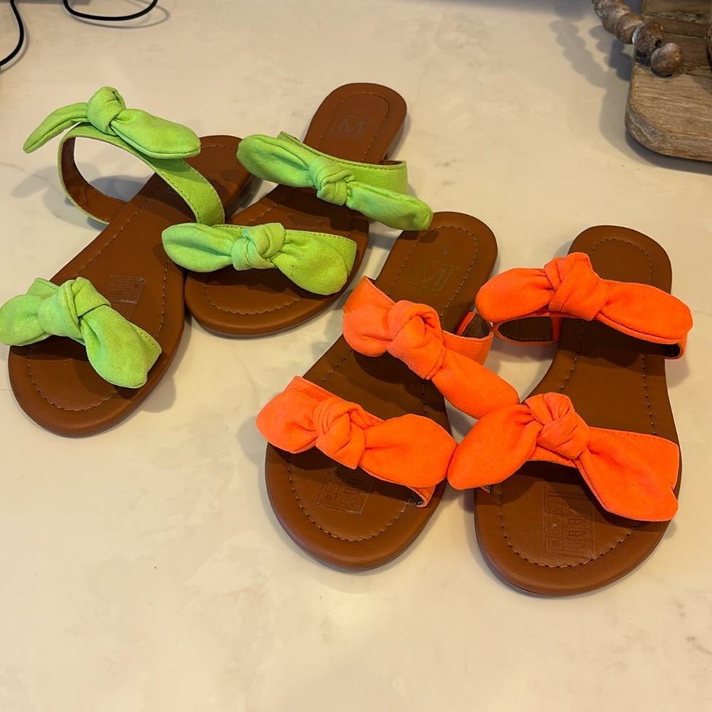 Two pairs of orange and green sandals